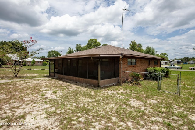 4422 SE 2nd Ave, Keystone Heights, FL 32656 - back of house featuring a sunroom and a gate