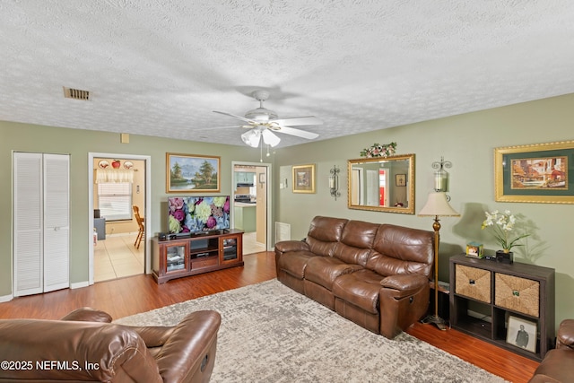 4422 SE 2nd Ave, Keystone Heights, FL 32656 - living area with a textured ceiling, ceiling fan, and wood finished floors