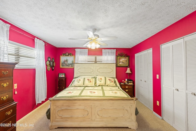 4422 SE 2nd Ave, Keystone Heights, FL 32656 - carpeted bedroom featuring multiple closets, a textured ceiling, and ceiling fan
