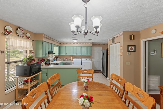 4422 SE 2nd Ave, Keystone Heights, FL 32656 - dining room with washer and dryer, a chandelier, light tile patterned floors, and a textured ceiling