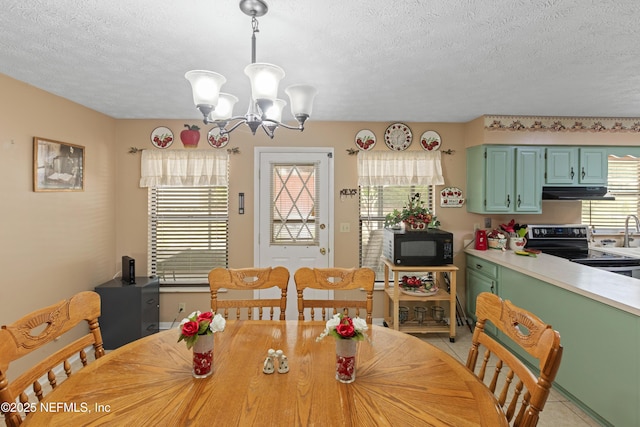 4422 SE 2nd Ave, Keystone Heights, FL 32656 - dining room with a chandelier, a textured ceiling, and light tile patterned floors