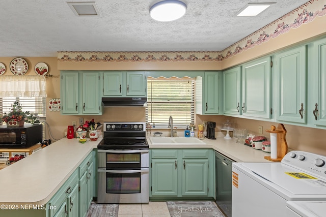 4422 SE 2nd Ave, Keystone Heights, FL 32656 - kitchen featuring appliances with stainless steel finishes, range hood, washer and dryer, light countertops, and a textured ceiling