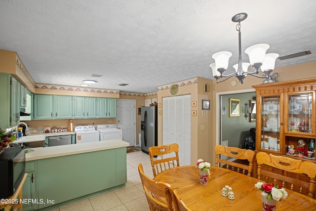 4422 SE 2nd Ave, Keystone Heights, FL 32656 - dining space featuring washing machine and dryer, a chandelier, light tile patterned flooring, and a textured ceiling