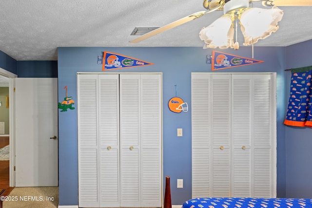 4422 SE 2nd Ave, Keystone Heights, FL 32656 - bedroom with two closets, a textured ceiling, and a chandelier