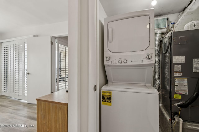 3350 Fletcher Ave Unit 6J, Fernandina Beach, FL 32034 - washroom featuring estacked washer and dryer and wood finished floors