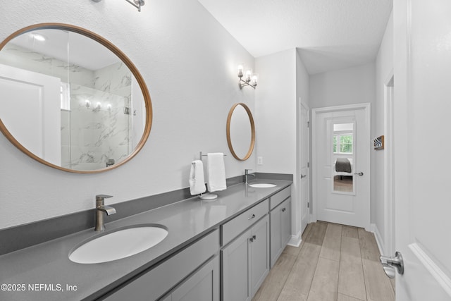 52 Key Grass Ct, Saint Johns, FL 32259 - bathroom with double vanity, a marble finish shower, and wood finished floors