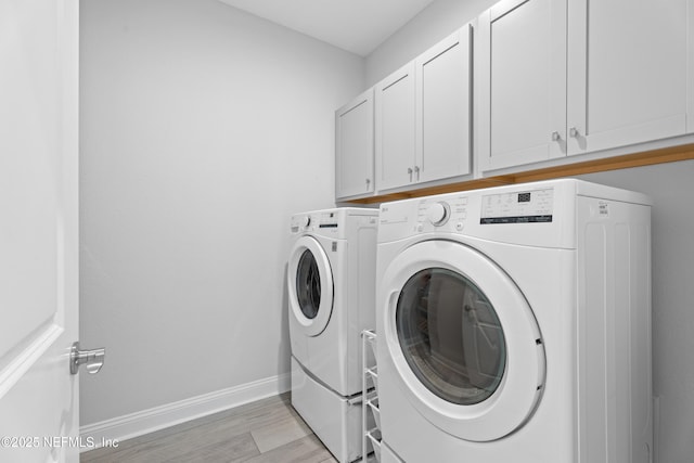 52 Key Grass Ct, Saint Johns, FL 32259 - washroom featuring washing machine and clothes dryer, cabinet space, and light wood finished floors