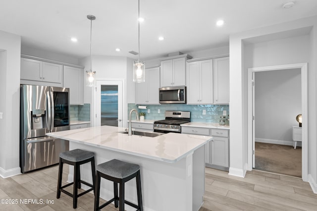 52 Key Grass Ct, Saint Johns, FL 32259 - kitchen featuring stainless steel appliances, light wood finished floors, an island with sink, tasteful backsplash, and recessed lighting