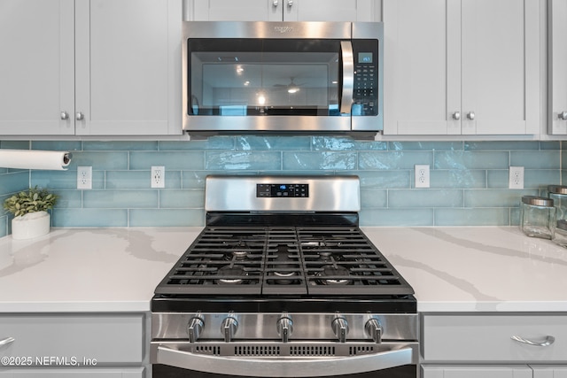 52 Key Grass Ct, Saint Johns, FL 32259 - kitchen featuring appliances with stainless steel finishes, white cabinets, and light stone countertops