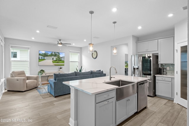 52 Key Grass Ct, Saint Johns, FL 32259 - kitchen with stainless steel appliances, open floor plan, light wood finished floors, and recessed lighting