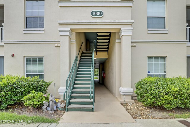 8601 Beach Blvd Unit 1008, Jacksonville, FL 32216 - doorway to property featuring stucco siding