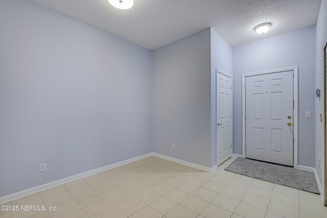 8601 Beach Blvd Unit 1008, Jacksonville, FL 32216 - entryway with light tile patterned flooring and a textured ceiling