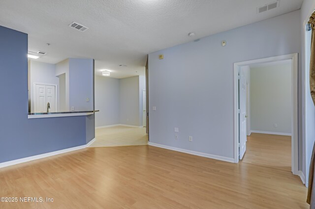 8601 Beach Blvd Unit 1008, Jacksonville, FL 32216 - empty room with light wood-style flooring and baseboards