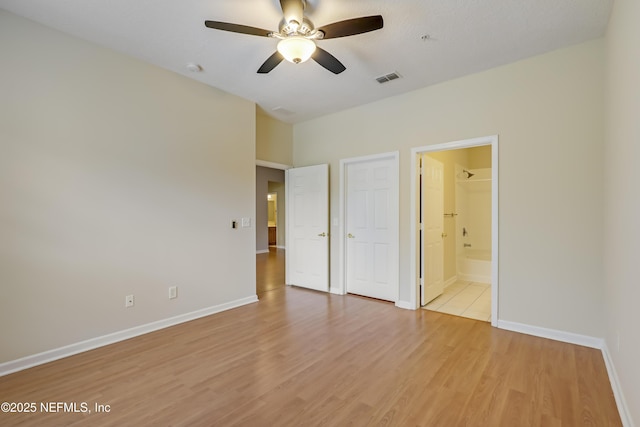 8601 Beach Blvd Unit 1008, Jacksonville, FL 32216 - unfurnished bedroom featuring light wood finished floors and ensuite bath
