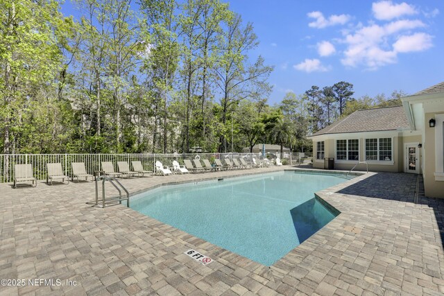 8601 Beach Blvd Unit 1008, Jacksonville, FL 32216 - community pool featuring a patio