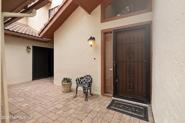 55 Village Cir, Palm Coast, FL 32164 - entrance to property featuring stucco siding and a patio area