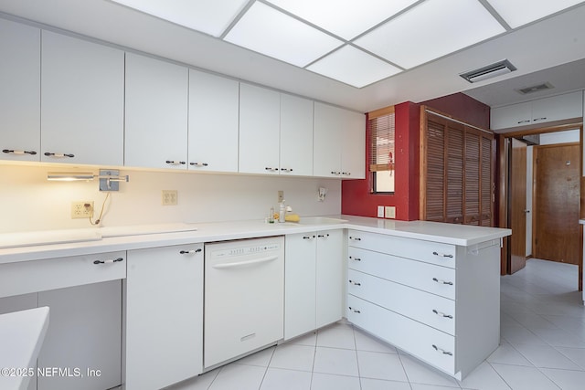 55 Village Cir, Palm Coast, FL 32164 - kitchen with dishwasher, a peninsula, light countertops, a sink, and light tile patterned floors