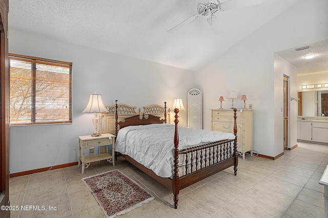 55 Village Cir, Palm Coast, FL 32164 - bedroom featuring light tile patterned flooring, lofted ceiling, a textured ceiling, ensuite bath, and baseboards