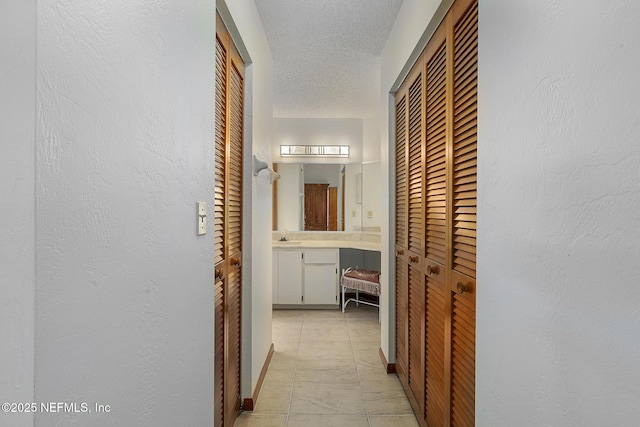55 Village Cir, Palm Coast, FL 32164 - hall with a textured ceiling, light tile patterned flooring, and a textured wall