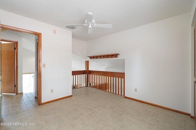 55 Village Cir, Palm Coast, FL 32164 - spare room with a ceiling fan, baseboards, and a textured ceiling