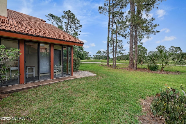 55 Village Cir, Palm Coast, FL 32164 - view of grassy yard with a sunroom