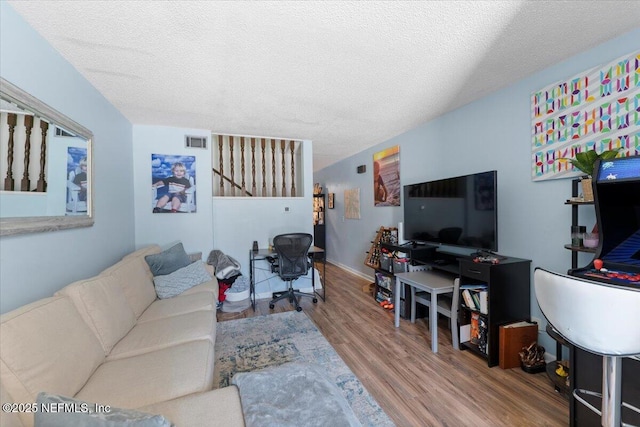 1506 Strand St, Neptune Beach, FL 32266 - living area with wood finished floors and a textured ceiling
