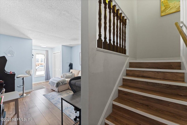 1506 Strand St, Neptune Beach, FL 32266 - staircase featuring a textured ceiling and wood finished floors