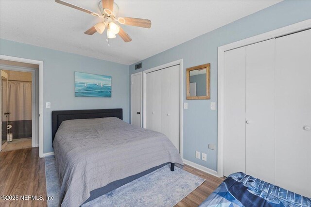 1506 Strand St, Neptune Beach, FL 32266 - bedroom with wood finished floors, two closets, and a ceiling fan