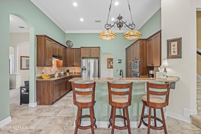 641 Donald Ross Way, Saint Augustine, FL 32092 - kitchen with stainless steel appliances, arched walkways, crown molding, a peninsula, and light stone counters