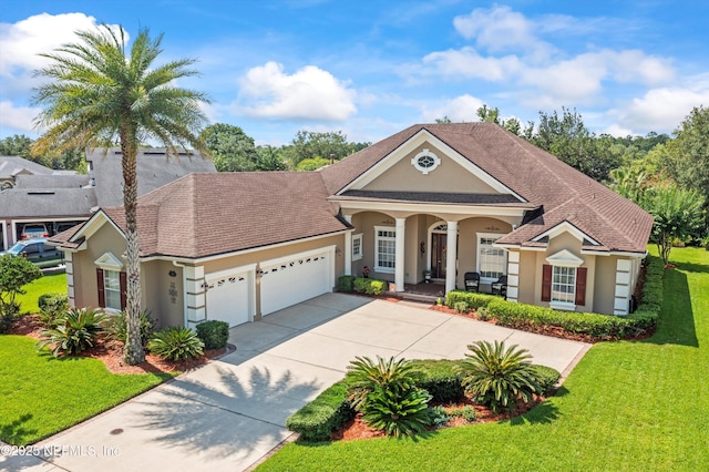 641 Donald Ross Way, Saint Augustine, FL 32092 - view of front of home with stucco siding, an attached garage, a porch, driveway, and a front yard