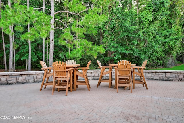 641 Donald Ross Way, Saint Augustine, FL 32092 - view of patio / terrace featuring outdoor dining space and view of wooded area