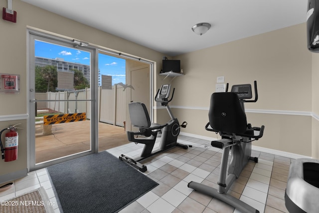 3060 N Atlantic Ave Unit 708, Cocoa Beach, FL 32931 - exercise room featuring light tile patterned floors and baseboards