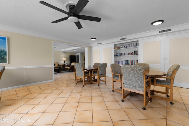 3060 N Atlantic Ave Unit 708, Cocoa Beach, FL 32931 - dining space featuring ornamental molding, a ceiling fan, light tile patterned floors, and a textured ceiling