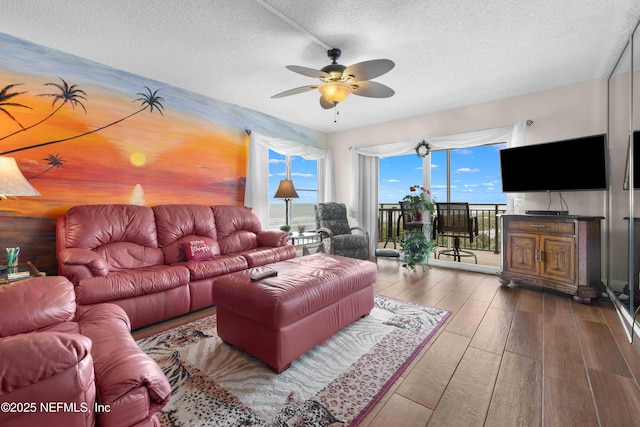 3060 N Atlantic Ave Unit 708, Cocoa Beach, FL 32931 - living room featuring a ceiling fan, wood finished floors, and a textured ceiling