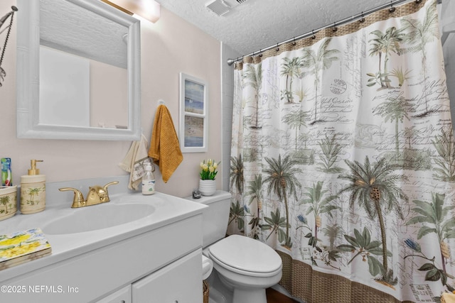 3060 N Atlantic Ave Unit 708, Cocoa Beach, FL 32931 - bathroom with vanity, toilet, a textured ceiling, and a shower with shower curtain