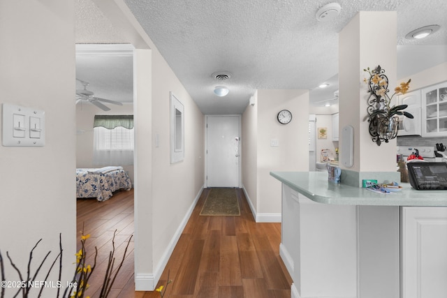 3060 N Atlantic Ave Unit 708, Cocoa Beach, FL 32931 - hall featuring a textured ceiling, wood finished floors, and baseboards