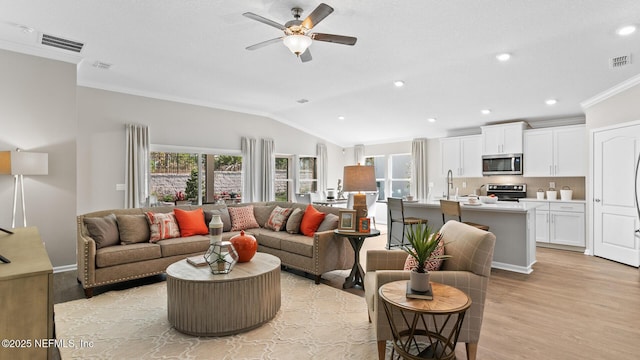71 Green Cir, Palm Coast, FL 32164 - living area featuring lofted ceiling, light wood-style floors, ceiling fan, ornamental molding, and recessed lighting