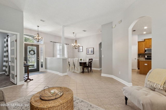 14220 Palmetto Springs St, Jacksonville, FL 32258 - living area featuring a chandelier, arched walkways, and light tile patterned floors