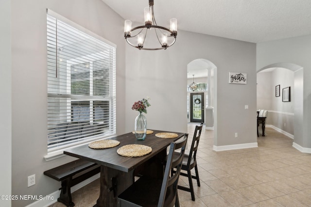 14220 Palmetto Springs St, Jacksonville, FL 32258 - dining area with arched walkways, a chandelier, and light tile patterned flooring