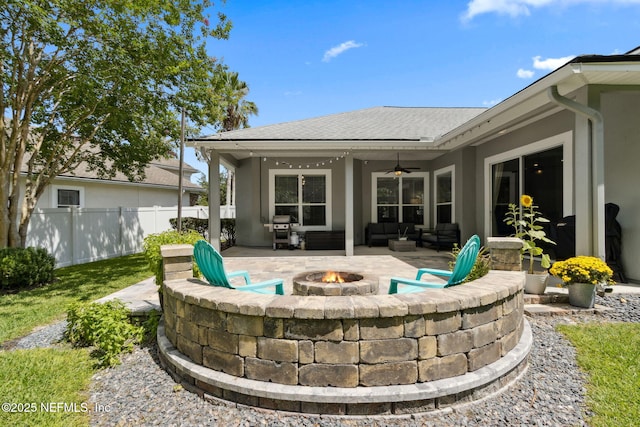 14220 Palmetto Springs St, Jacksonville, FL 32258 - rear view of house with ceiling fan, a patio, an outdoor living space with a fire pit, stucco siding, and roof with shingles