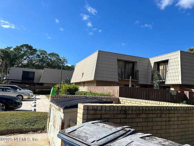5706 57th Way, West Palm Beach, FL 33409 - view of home's exterior featuring mansard roof and brick siding