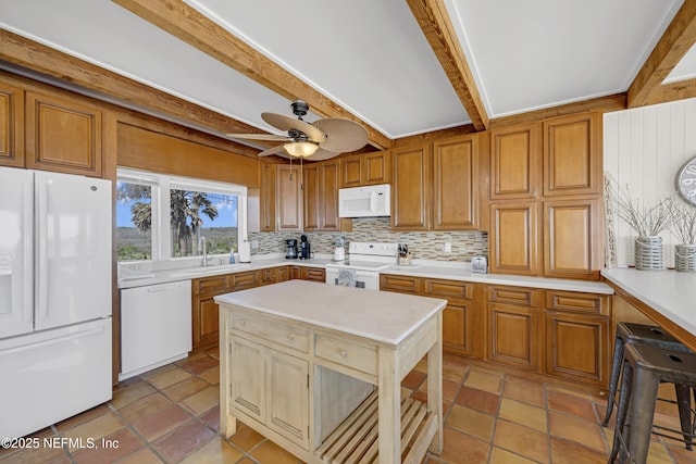 2947 S Ponte Vedra Blvd, Ponte Vedra Beach, FL 32082 - kitchen with white appliances, decorative backsplash, beam ceiling, light countertops, and ceiling fan