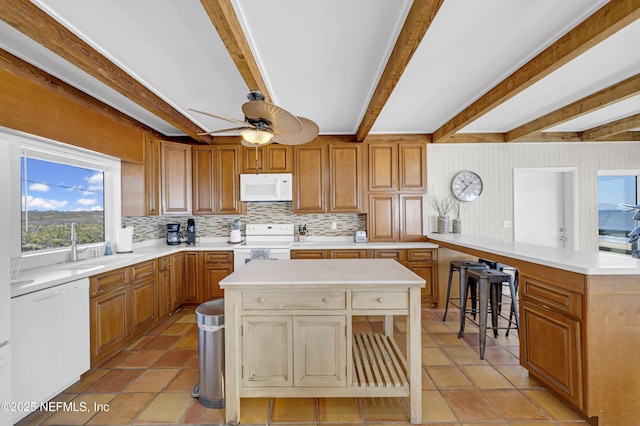 2947 S Ponte Vedra Blvd, Ponte Vedra Beach, FL 32082 - kitchen with white appliances, a peninsula, backsplash, light countertops, and beam ceiling