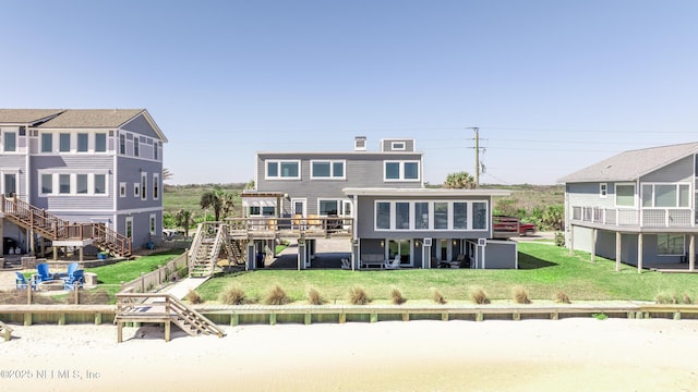 2947 S Ponte Vedra Blvd, Ponte Vedra Beach, FL 32082 - back of house featuring stairs, a lawn, and a deck
