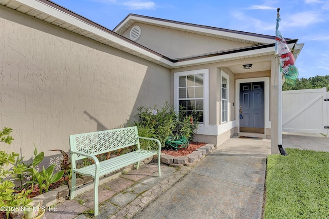 1908 Longneedle Ln, Middleburg, FL 32068 - view of exterior entry featuring stucco siding and a gate