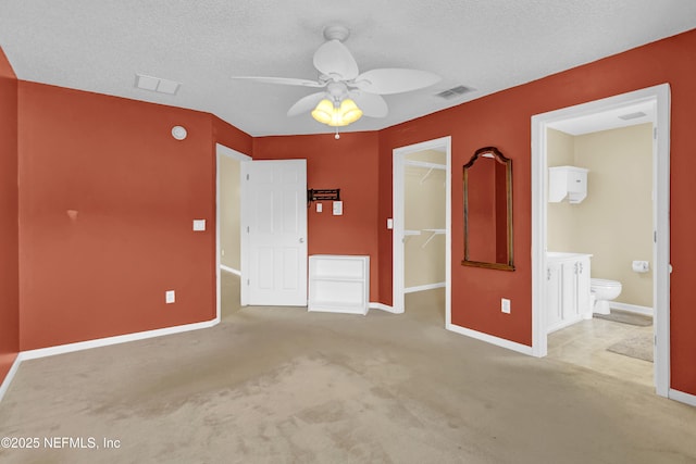 1908 Longneedle Ln, Middleburg, FL 32068 - unfurnished bedroom with a spacious closet, baseboards, a closet, carpet, and a textured ceiling