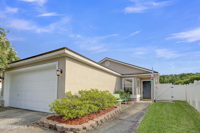 1908 Longneedle Ln, Middleburg, FL 32068 - view of front facade with a gate, stucco siding, a garage, and driveway