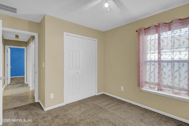 1908 Longneedle Ln, Middleburg, FL 32068 - unfurnished bedroom featuring carpet, a textured ceiling, a closet, baseboards, and ceiling fan
