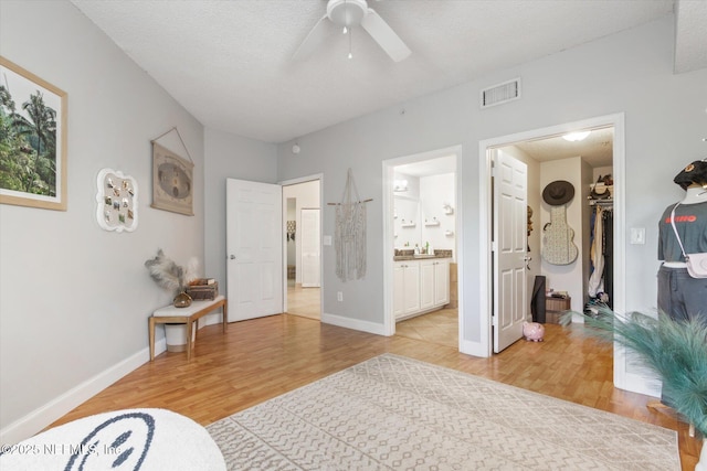 4000 Grande Vista Blvd Unit 15-206, Saint Augustine, FL 32084 - bedroom with light wood finished floors, a spacious closet, connected bathroom, ceiling fan, and a closet