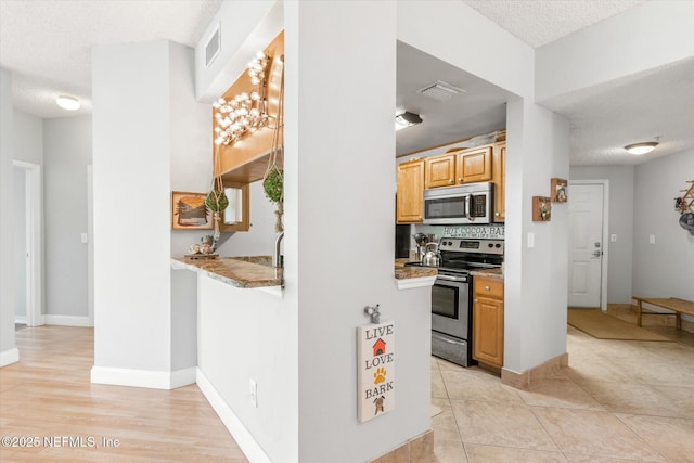 4000 Grande Vista Blvd Unit 15-206, Saint Augustine, FL 32084 - kitchen featuring appliances with stainless steel finishes and a textured ceiling